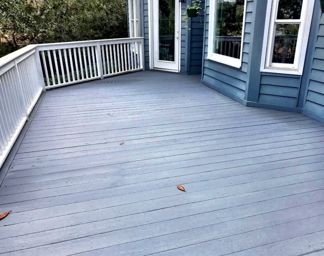 Refinished blue-gray wood deck with white railing