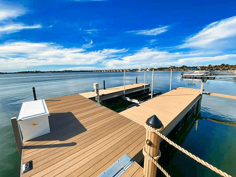 Residential composite boat dock extending into the Intracoastal under a bright blue sky